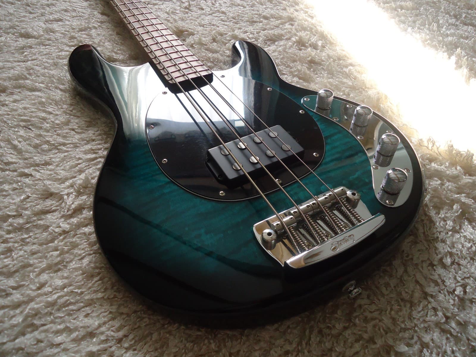 Sterling by Music Man Stingray Ray34 Teal Green Flame Top Bass Guitar.