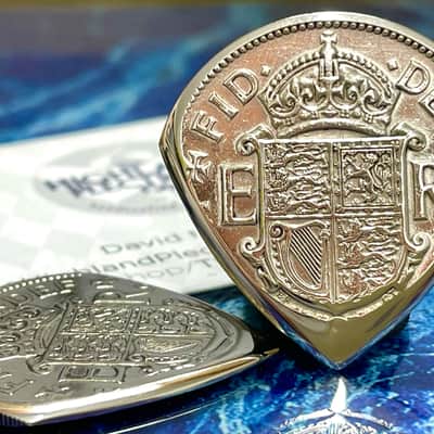 The Highland Plectrum Co. One Queen Elizabeth Half Crown Coin Electric Guitar Pick.
